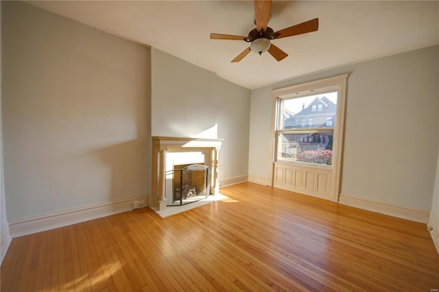 unfurnished living room featuring ceiling fan, vaulted ceiling, and light hardwood / wood-style flooring