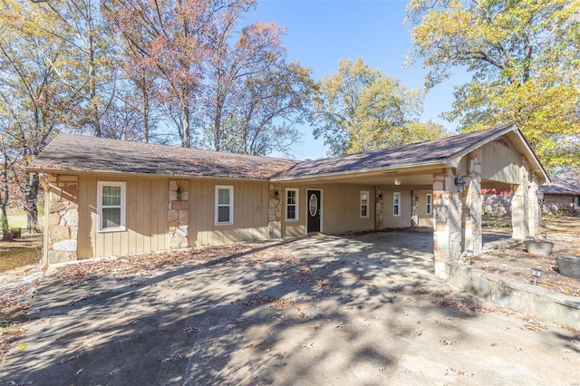 ranch-style house featuring a carport