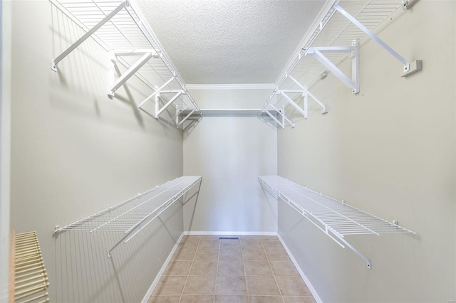 walk in closet with tile patterned floors