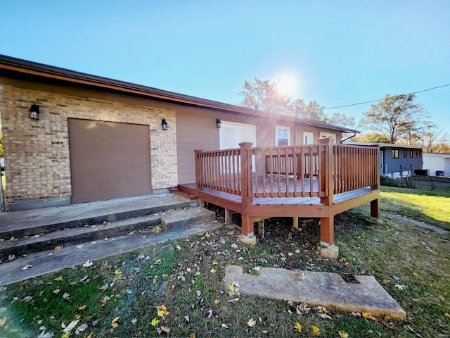 rear view of property featuring a wooden deck