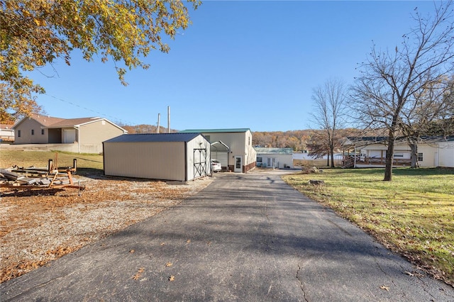 view of home's exterior with a yard and a shed