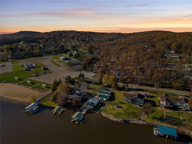 aerial view at dusk with a water view