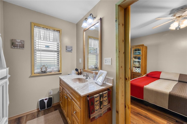 bathroom with ceiling fan, vanity, and hardwood / wood-style floors