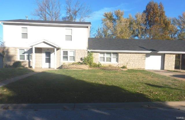 view of front of home with a garage and a front yard