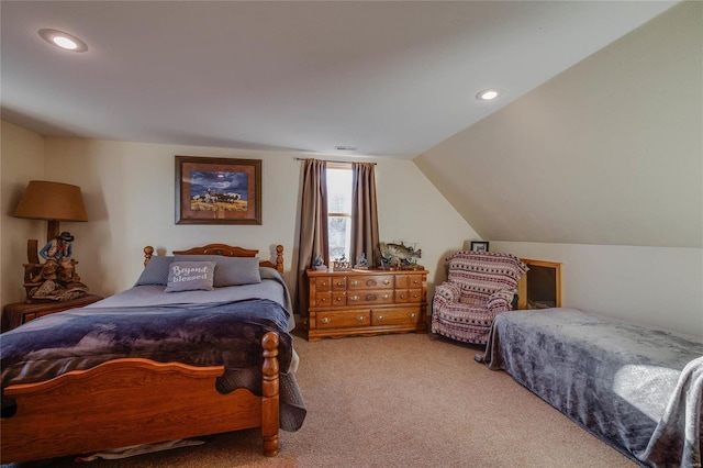 carpeted bedroom with lofted ceiling