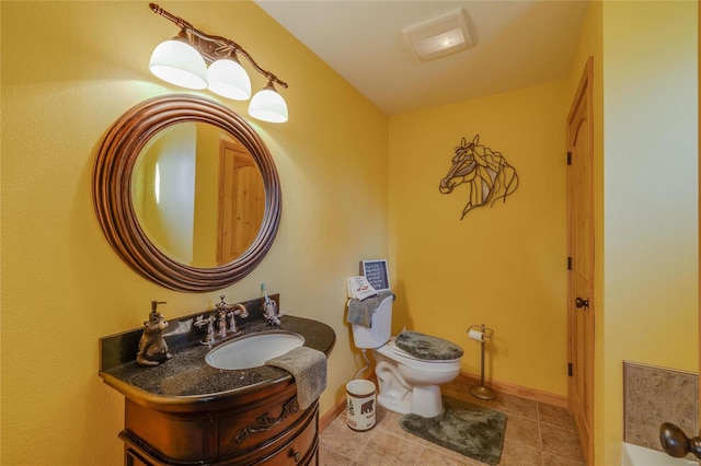 bathroom with tile patterned floors, vanity, and toilet