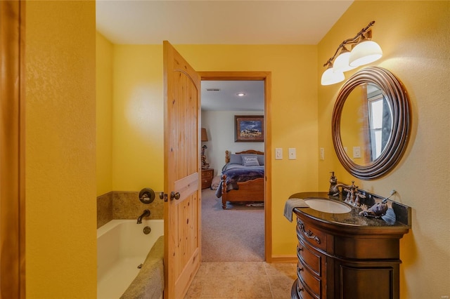 bathroom with tile patterned floors, vanity, and a bath