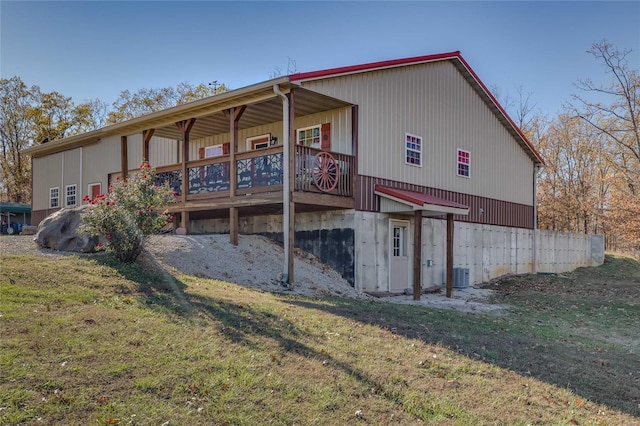 back of house featuring a yard and central air condition unit