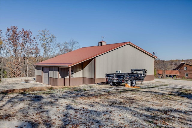 view of side of home featuring an outbuilding