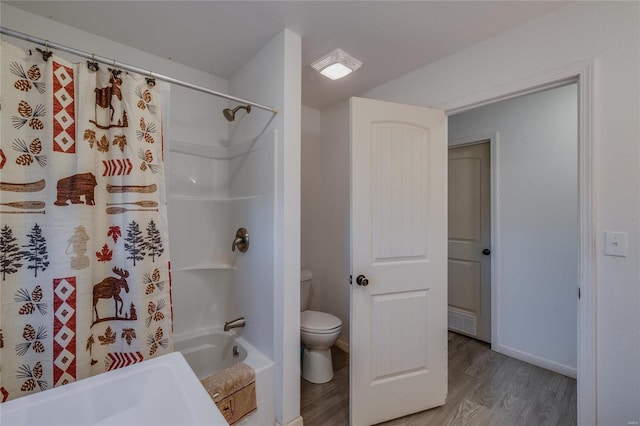 bathroom with hardwood / wood-style floors, shower / bath combination with curtain, and toilet