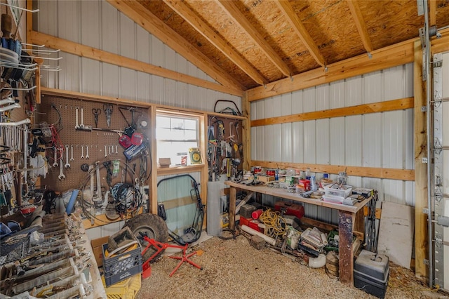 interior space with a workshop area and vaulted ceiling