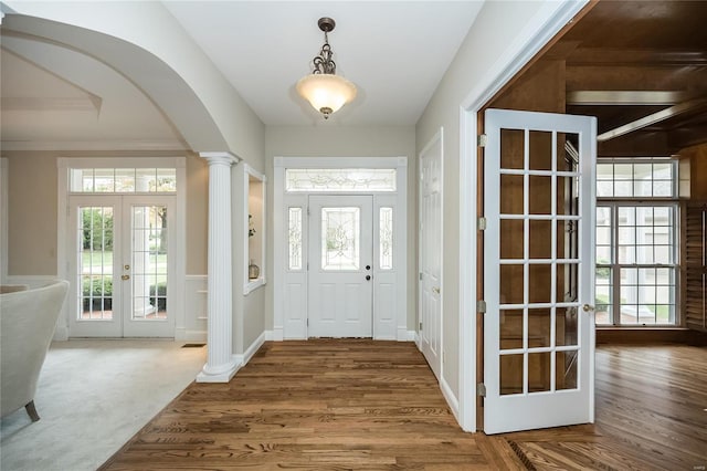 foyer with hardwood / wood-style flooring, plenty of natural light, and french doors