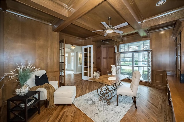 interior space featuring hardwood / wood-style flooring, beam ceiling, wooden walls, and french doors