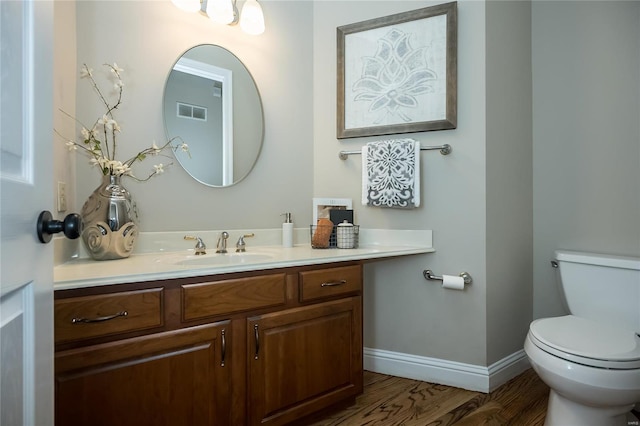 bathroom featuring hardwood / wood-style floors, vanity, and toilet