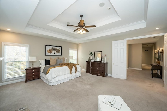 carpeted bedroom featuring a raised ceiling, ceiling fan, and crown molding