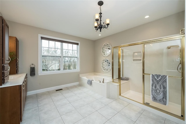 bathroom with tile patterned floors, vanity, independent shower and bath, and a chandelier