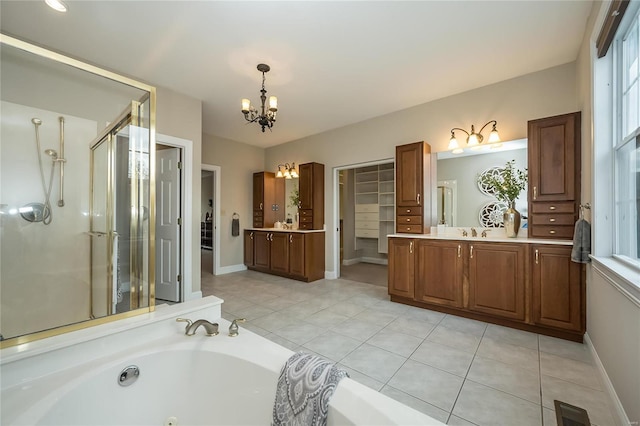 bathroom featuring tile patterned floors, vanity, independent shower and bath, and a notable chandelier