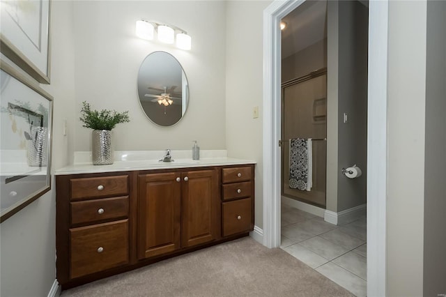 bathroom with tile patterned floors, ceiling fan, vanity, and walk in shower