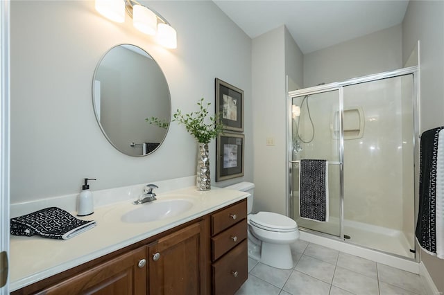 bathroom featuring toilet, vanity, tile patterned floors, and walk in shower