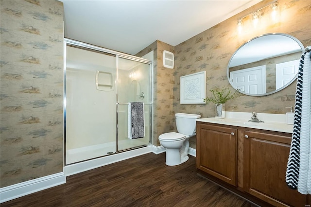 bathroom with wood-type flooring, vanity, toilet, and walk in shower