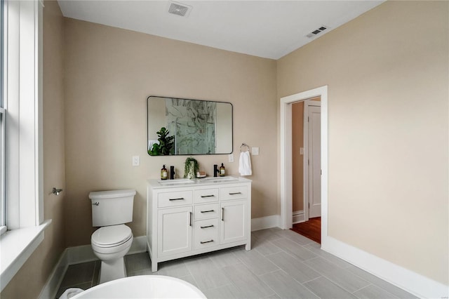 bathroom featuring vanity, tile patterned floors, and toilet