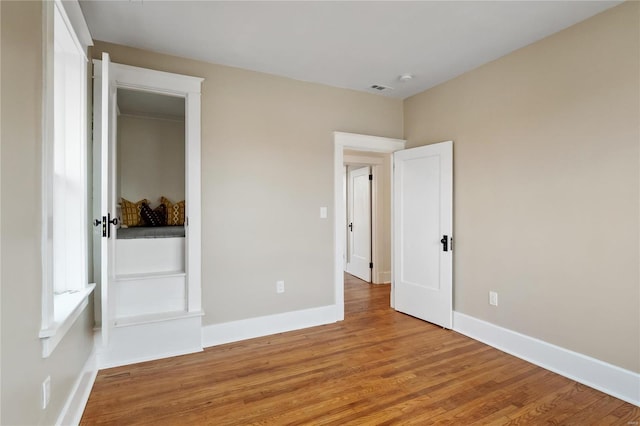 unfurnished bedroom with hardwood / wood-style floors