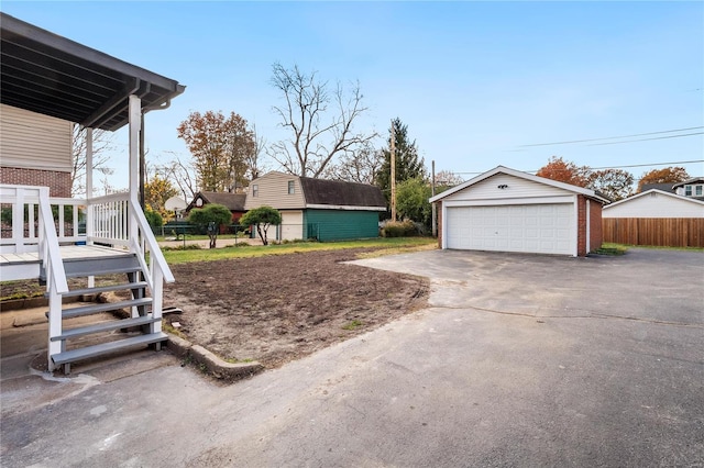 view of yard featuring a garage and an outdoor structure