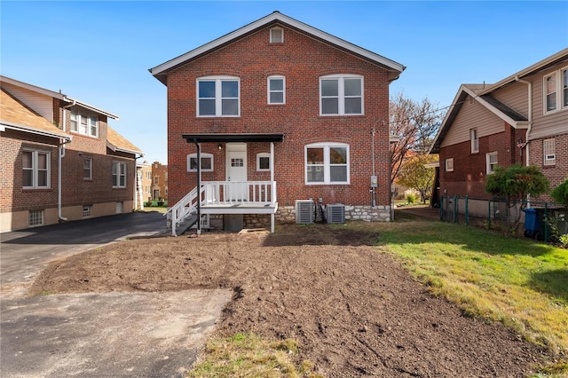 view of front of house featuring a front yard and central air condition unit