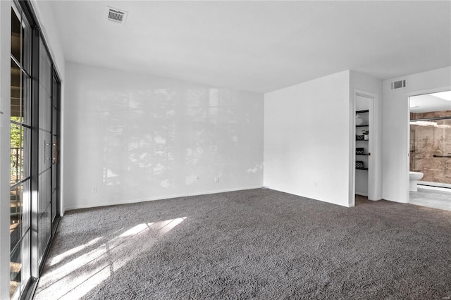 empty room with dark colored carpet