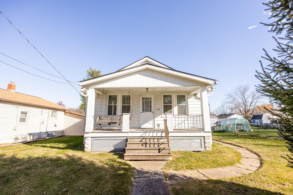 bungalow-style house featuring a front yard and a porch