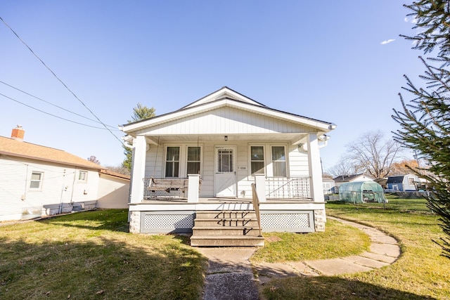 bungalow-style house featuring a front yard and a porch