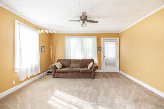 living room with light carpet, ceiling fan, and ornamental molding