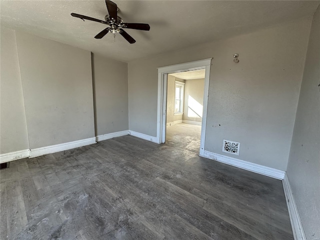 unfurnished room with dark hardwood / wood-style flooring, a textured ceiling, and ceiling fan