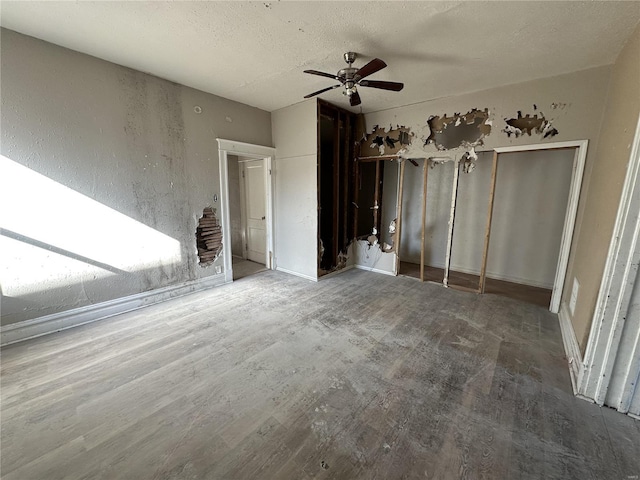 unfurnished bedroom with ceiling fan and a textured ceiling