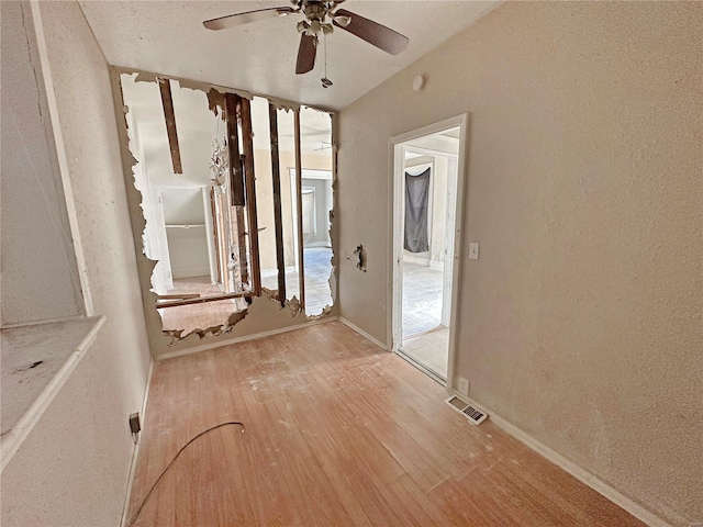 empty room featuring ceiling fan and light wood-type flooring