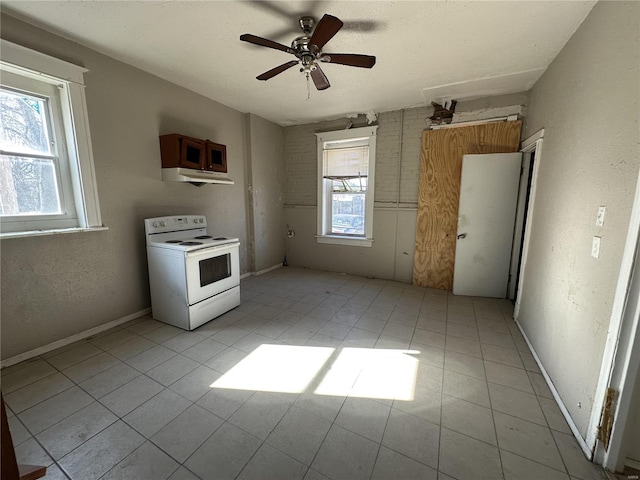 kitchen with light tile patterned floors, electric range, a healthy amount of sunlight, and ceiling fan