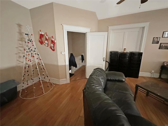 living room with wood-type flooring and ceiling fan