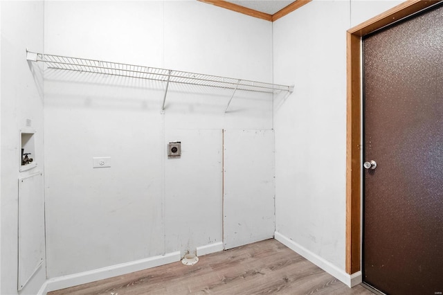 clothes washing area with electric dryer hookup, crown molding, hookup for a washing machine, and light wood-type flooring