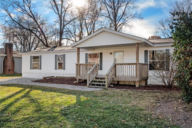 single story home featuring a front lawn and covered porch