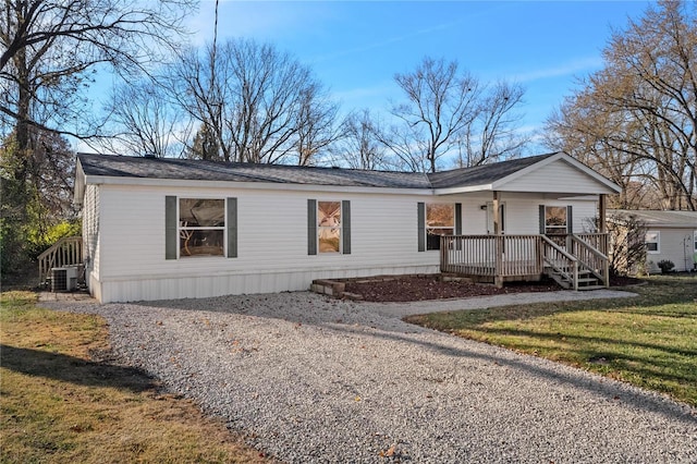 view of front of house featuring a front lawn, a porch, and cooling unit