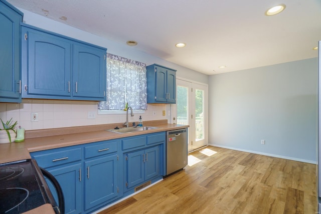 kitchen featuring tasteful backsplash, stainless steel dishwasher, blue cabinets, sink, and light hardwood / wood-style floors