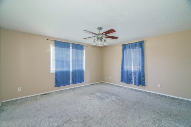 carpeted spare room with ceiling fan