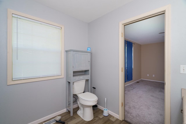 bathroom with wood-type flooring and toilet