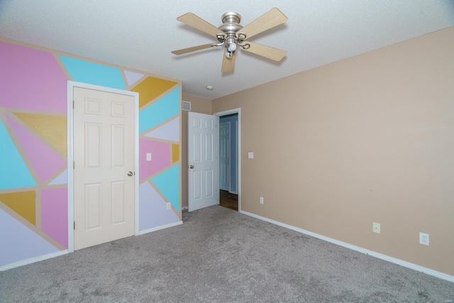 unfurnished bedroom with ceiling fan and carpet flooring