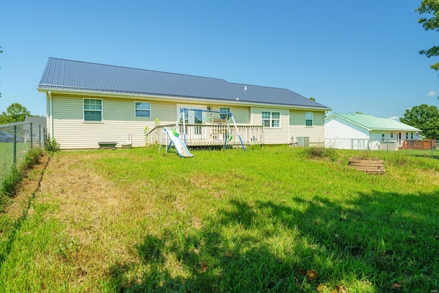 back of property featuring a yard and a deck