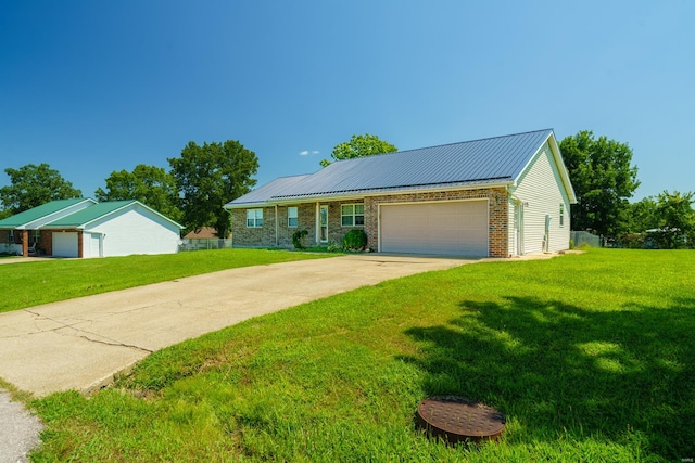 view of front of property with a garage and a front lawn