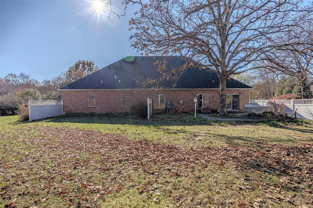 back of house featuring a lawn