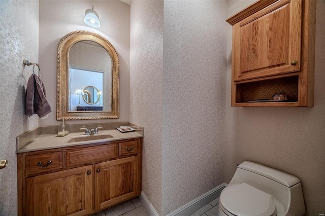 bathroom featuring tile patterned floors, vanity, and toilet