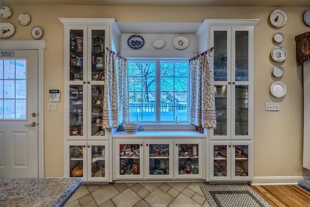 interior space featuring white cabinetry, a wealth of natural light, and light hardwood / wood-style flooring