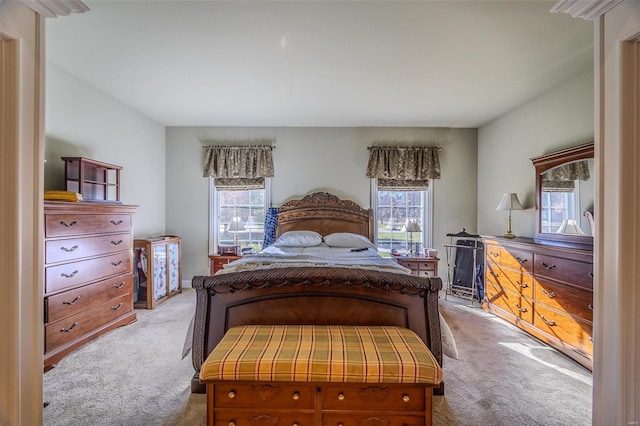 bedroom featuring light carpet and multiple windows